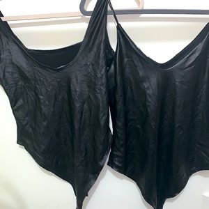 Two black leathery bodysuits.